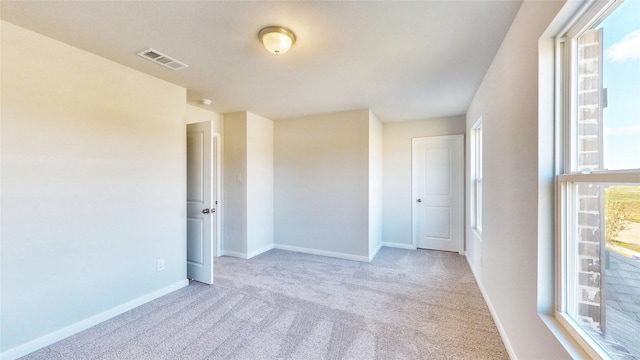 spare room with light colored carpet