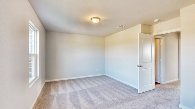 carpeted empty room with a healthy amount of sunlight