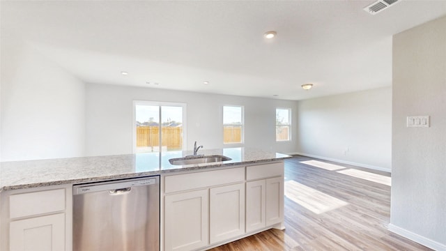 kitchen with light hardwood / wood-style floors, white cabinets, sink, and stainless steel dishwasher