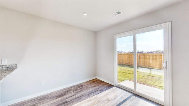 unfurnished room with light wood-type flooring