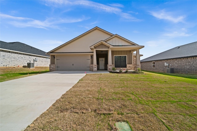 craftsman house with a garage, a front lawn, and cooling unit