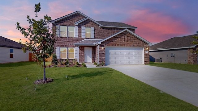 front facade featuring cooling unit, a garage, and a lawn