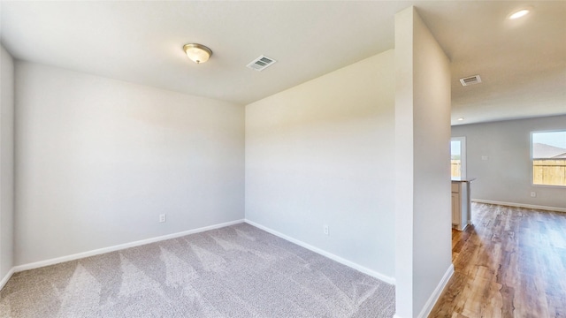 spare room with wood-type flooring