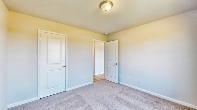 unfurnished bedroom featuring light colored carpet