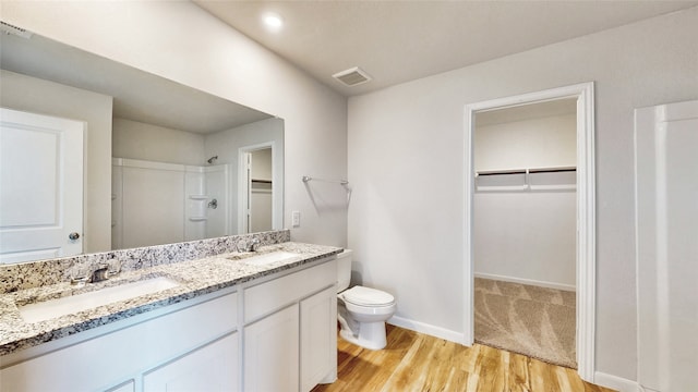 bathroom featuring hardwood / wood-style flooring, toilet, and vanity