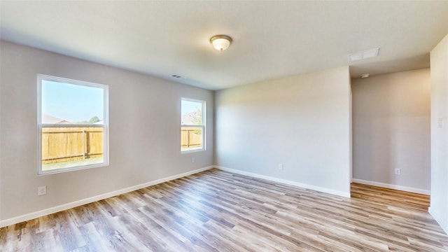 empty room with light hardwood / wood-style flooring