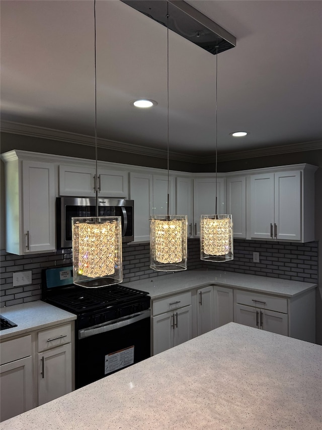 kitchen featuring white cabinetry, tasteful backsplash, decorative light fixtures, and range with gas stovetop