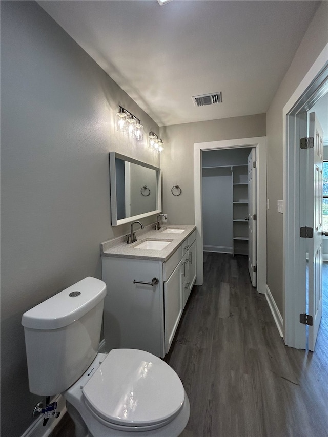 bathroom featuring hardwood / wood-style flooring, vanity, and toilet