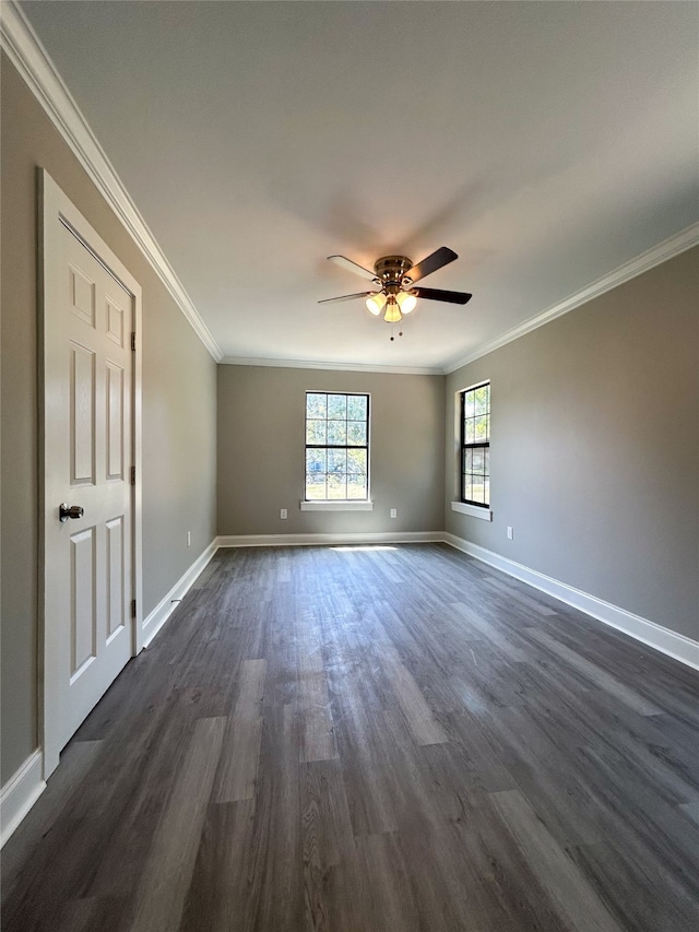 unfurnished room featuring dark hardwood / wood-style flooring, ornamental molding, and ceiling fan