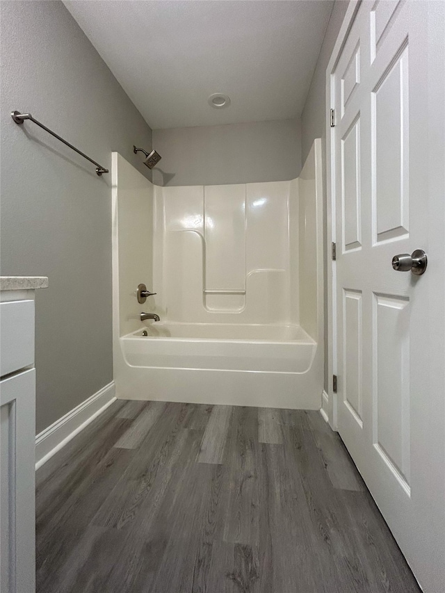 bathroom with  shower combination, vanity, and hardwood / wood-style floors