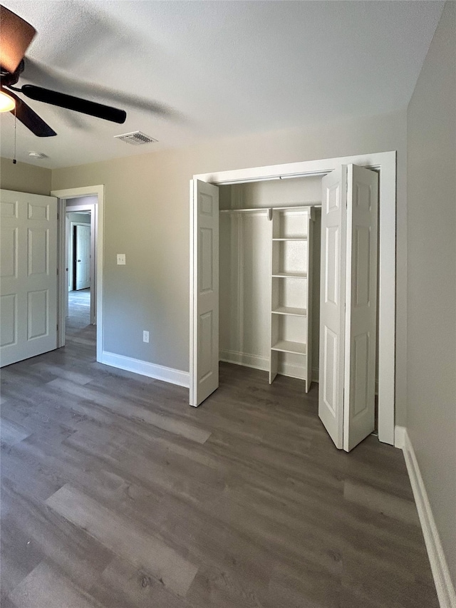 unfurnished bedroom featuring ceiling fan and dark hardwood / wood-style floors