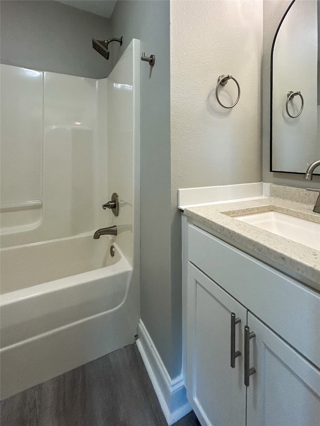 bathroom featuring bathing tub / shower combination, hardwood / wood-style flooring, and vanity