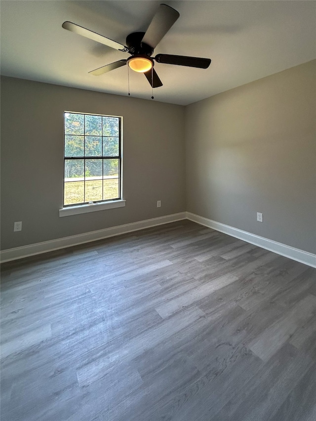 spare room with ceiling fan and dark hardwood / wood-style flooring