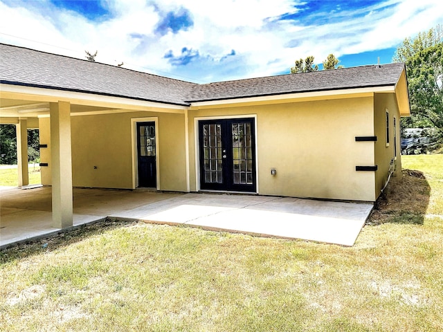 back of property featuring a patio and a lawn