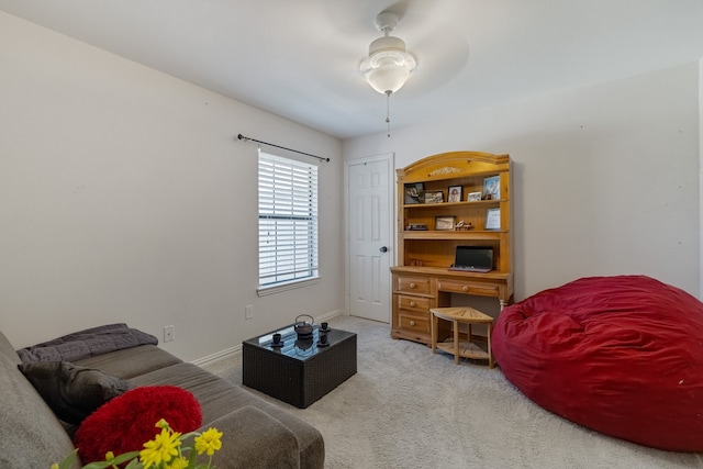 living area with ceiling fan and carpet flooring