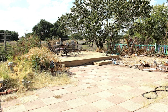 view of patio / terrace with outdoor dining area, fence, and a deck