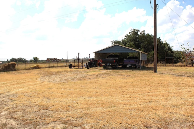 view of yard with a carport and fence