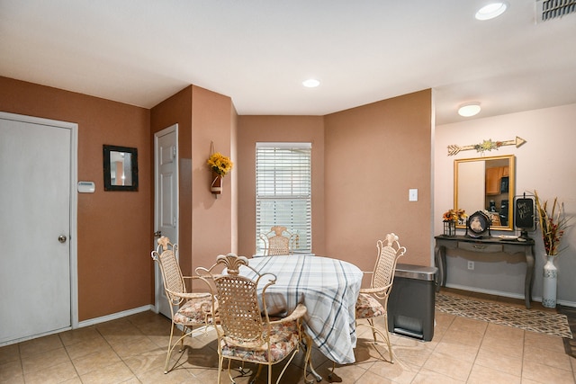 dining space featuring light tile patterned flooring