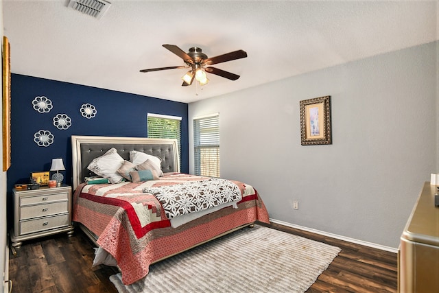 bedroom with ceiling fan and dark hardwood / wood-style flooring