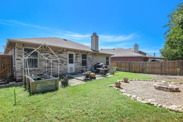 rear view of property featuring a patio and a lawn