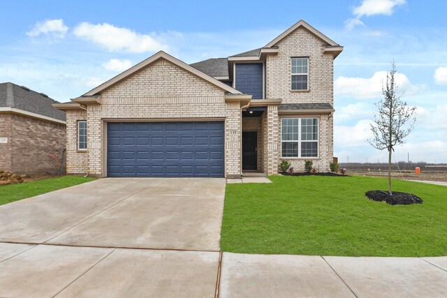 view of front property with a yard and a garage