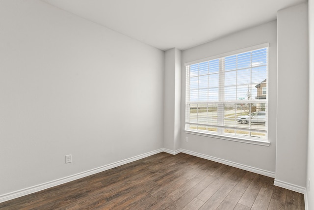 empty room with dark wood-type flooring