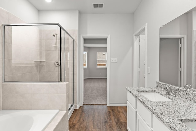 bathroom featuring vanity, hardwood / wood-style floors, and shower with separate bathtub