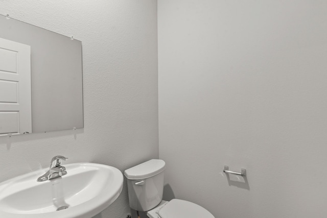 bathroom featuring sink and toilet