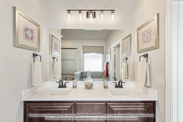 bathroom featuring a shower with shower door and vanity