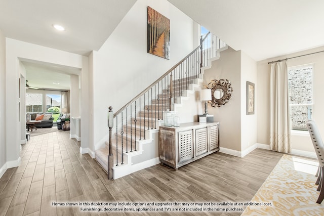 stairway with hardwood / wood-style floors