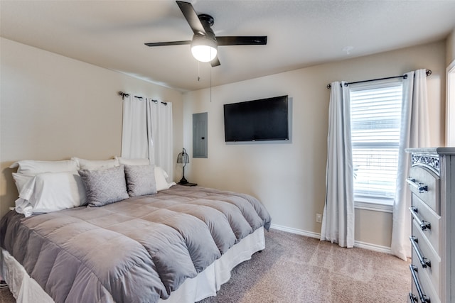 bedroom with light colored carpet, electric panel, and ceiling fan