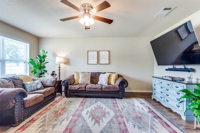 living room featuring a textured ceiling, ceiling fan, and wood-type flooring