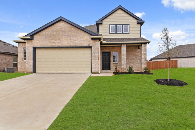 view of front of property with a yard and a garage