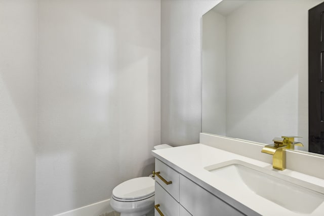 bathroom featuring toilet and vanity