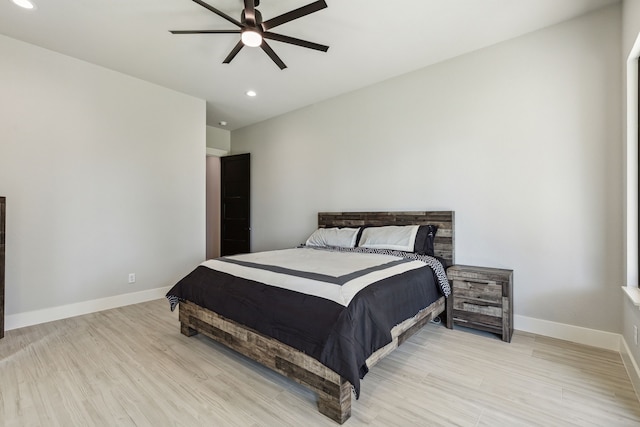 bedroom with ceiling fan and light hardwood / wood-style flooring