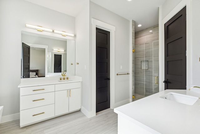 bathroom featuring an enclosed shower and vanity