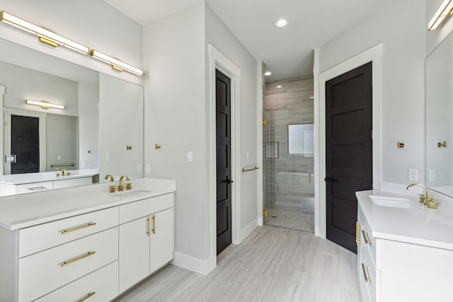 bathroom with tile patterned flooring, a shower with door, and vanity