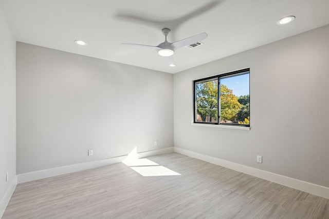 spare room with ceiling fan and light wood-type flooring