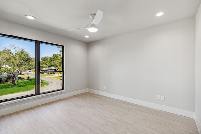 empty room with ceiling fan and plenty of natural light