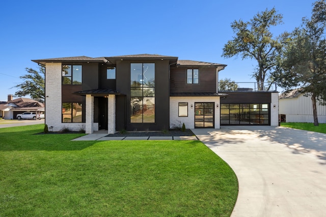 contemporary home featuring a front lawn