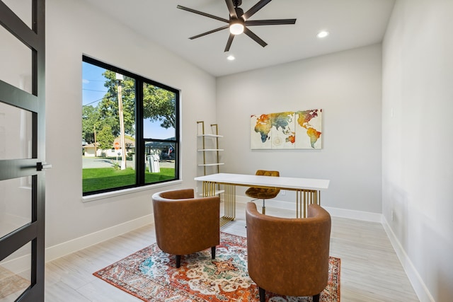 office area with a wealth of natural light, ceiling fan, and light hardwood / wood-style floors