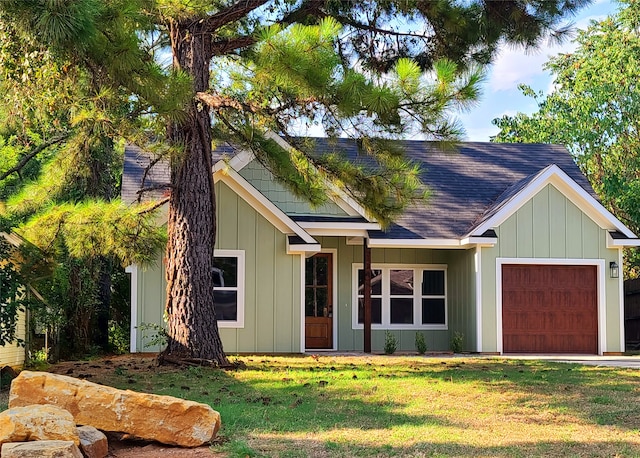 view of front of property featuring a garage and a front yard