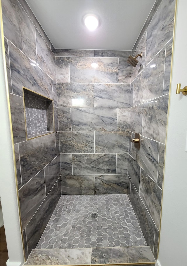 bathroom with a tile shower