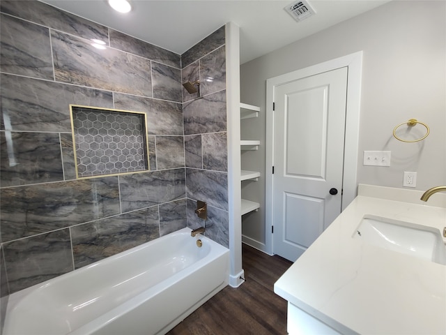 bathroom with vanity, tiled shower / bath combo, and hardwood / wood-style floors