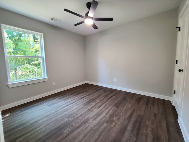 empty room featuring ceiling fan and dark hardwood / wood-style floors