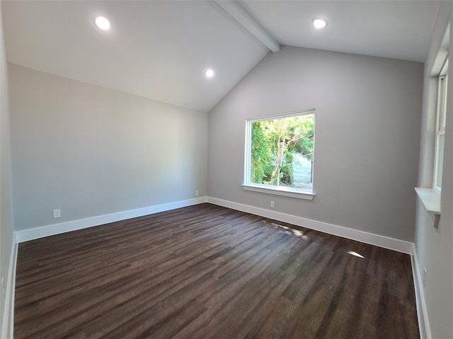 empty room featuring lofted ceiling with beams and dark hardwood / wood-style floors