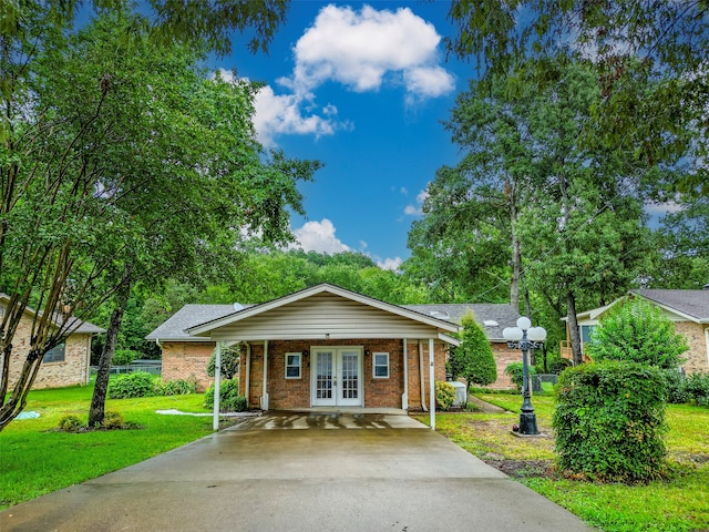 single story home with french doors and a front lawn