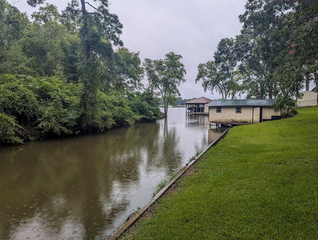 dock area featuring a yard and a water view