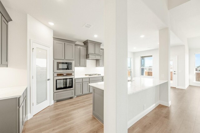 dining space featuring light hardwood / wood-style flooring and a healthy amount of sunlight