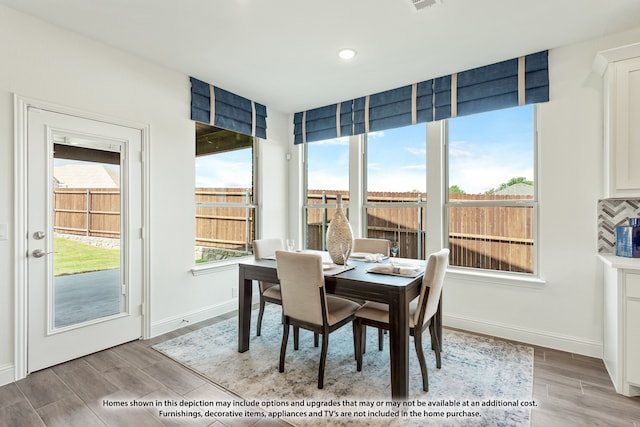 dining area with light hardwood / wood-style floors